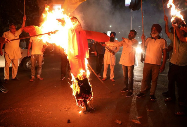 protestors burn an effigy of yogi adityanath chief minister of the northern state of uttar pradesh during a protest after people were killed when a car linked to a federal minister ran over farmers protesting against controversial farm laws in uttar pradesh on sunday in kolkata india october 4 2021 reuters protestors burn an effigy of yogi adityanath chief minister of the northern state of uttar pradesh during a protest after people were killed when a car linked to a federal minister ran over farmers protesting against controversial farm laws in uttar pradesh on sunday in kolkata india october 4 2021 reuters