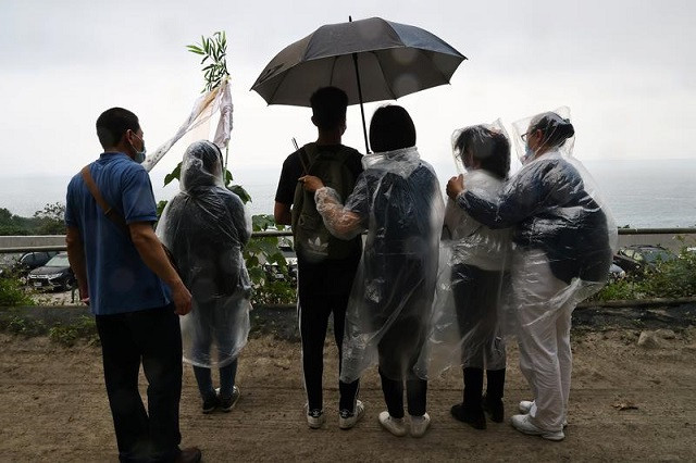 relatives of the victims mourn near the site a day after the deadly train derailment at a tunnel north of hualien taiwan april 3 2021 photo reuters