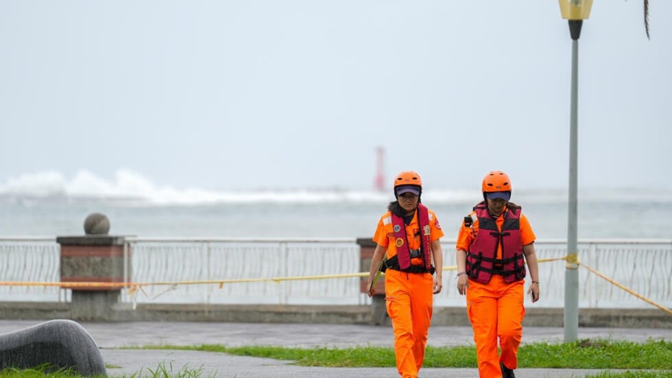 waves break off sizihwan bay beauty spot in kaohsiung as coast guard officers patrol ahead of the arrival of super typhoon krathon photo afp