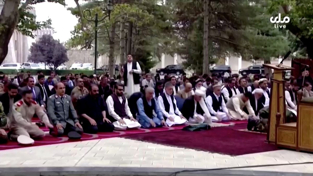 a man looks up as he reacts to the sounds of rocket explosions landing near the presidential palace during an outdoor gathering for eid al adha prayers attended by president ashraf ghani front row in the palace compound in kabul afghanistan july 20 2021 in this still image taken from tv footage rta via reuters