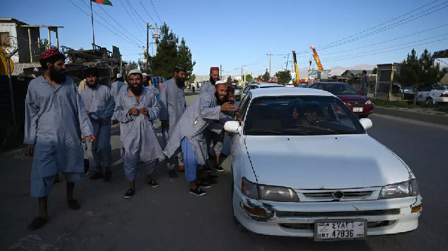 taliban prisoners stop a local taxi after their release from afghanistan s bagram prison photo afp file