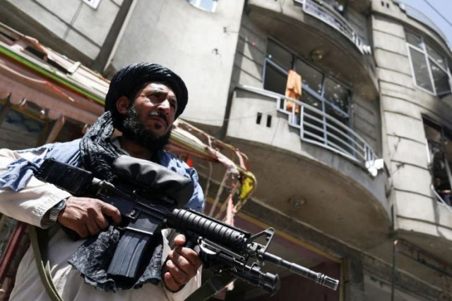 a taliban fighter stands guard at the site where an explosive laden vehicle detonated amidst an attack on a sikh temple in kabul afghanistan june 18 2022 photo reuters a taliban fighter stands guard at the site where an explosive laden vehicle detonated amidst an attack on a sikh temple in kabul afghanistan june 18 2022 photo reuters