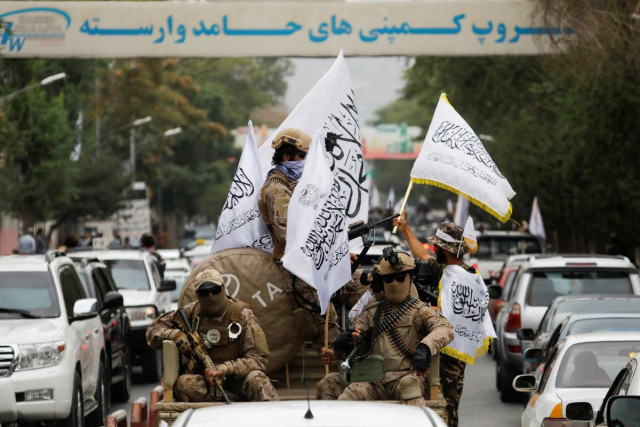taliban fighters hold islamic emirate of afghanistan flags as they drive though kabul reuters photo taliban fighters hold islamic emirate of afghanistan flags as they drive though kabul reuters photo