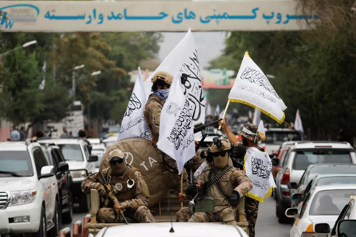 taliban fighters hold islamic emirate of afghanistan flags as they drive though kabul reuters photo taliban fighters hold islamic emirate of afghanistan flags as they drive though kabul reuters photo