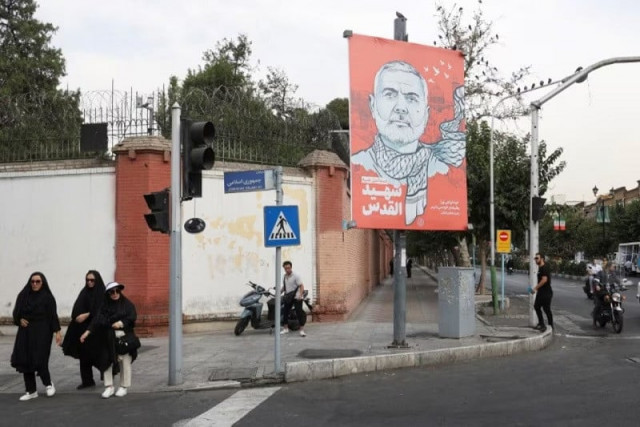 people walk past a banner with a picture of late hamas leader ismail haniyeh in a street in tehran iran august 12 2024 photo reuters people walk past a banner with a picture of late hamas leader ismail haniyeh in a street in tehran iran august 12 2024 photo reuters