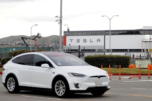 a tesla vehicle drives past tesla s primary vehicle factory after ceo elon musk announced he was defying local officials coronavirus disease covid 19 restrictions by reopening the plant in fremont california u s may 11 2020 photo reuters a tesla vehicle drives past tesla s primary vehicle factory after ceo elon musk announced he was defying local officials coronavirus disease covid 19 restrictions by reopening the plant in fremont california u s may 11 2020 photo reuters