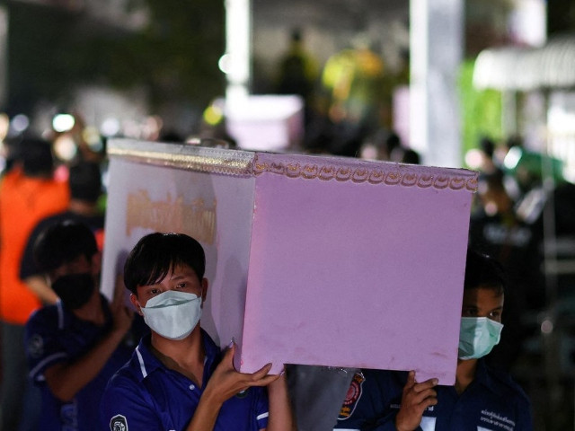 rescue workers carry a coffin containing the body of a victim at udon thani hospital in udon thani province following a mass shooting in the town of uthai sawan around 500 km northeast of bangkok in the province of nong bua lam phu thailand october 7 2022 reuters athit perawongmetha