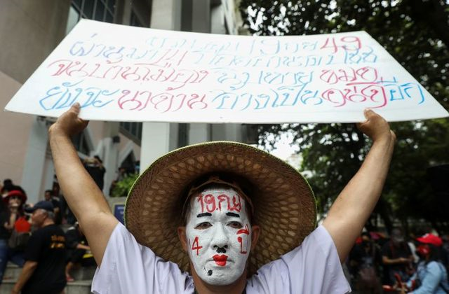 a pro democracy protester with a painted face holds a placard as he attends a mass rally to call for the ouster of prime minister prayuth chan ocha s government and reforms in the monarchy in bangkok thailand september 19 2020 photo reuters a pro democracy protester with a painted face holds a placard as he attends a mass rally to call for the ouster of prime minister prayuth chan ocha s government and reforms in the monarchy in bangkok thailand september 19 2020 photo reuters