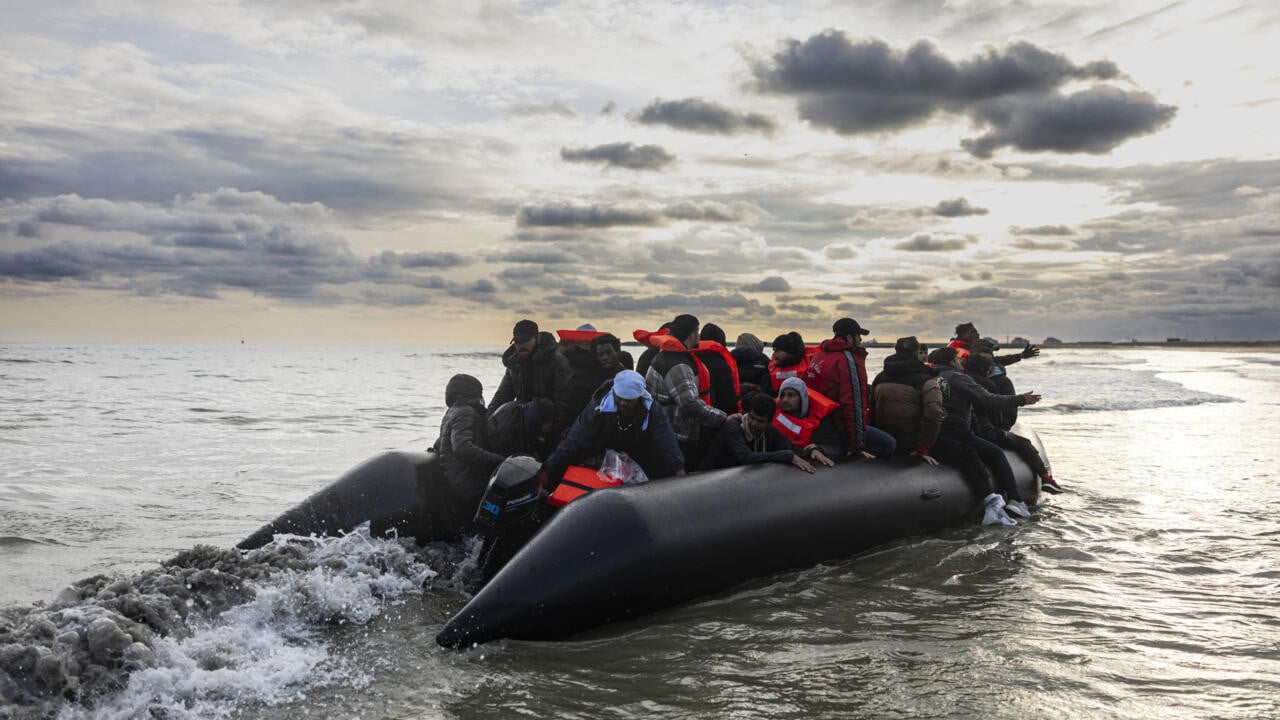 migrants board a smuggler s boat on the beach of gravelines in northern france on april 26 2024 file photo afp