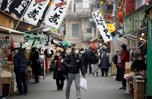 shoppers wearing protective face masks walk on the street at tsukiji outer market amid the coronavirus disease covid 19 outbreak in tokyo japan december 24 2020 photo reuters shoppers wearing protective face masks walk on the street at tsukiji outer market amid the coronavirus disease covid 19 outbreak in tokyo japan december 24 2020 photo reuters