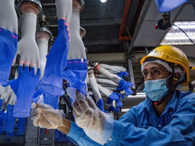 a worker on the production line of a top glove factory in shah alam near kuala lumpur in august 2020 photo afp file