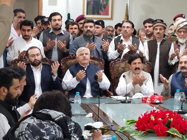 tribal elders and government officials hold prayers after their successful talks in jani khel bannu k p on march 29 2021 photo express