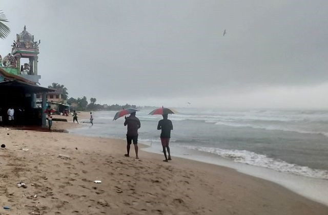 two men walk along a beach as cyclone burevi is expected to hit near the coast of trincomalee sri lanka december 2 2020 photo reuters two men walk along a beach as cyclone burevi is expected to hit near the coast of trincomalee sri lanka december 2 2020 photo reuters