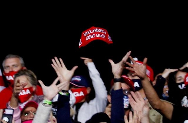 us president donald trump supporters try to catch a hat during a campaign event in fayetteville north carolina us september 19 2020 photo reuters