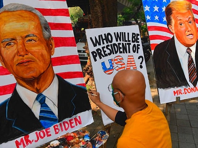 An Indian art school teacher paints an image of Democratic Presidential Candidate and former Vice President Joe Biden next to the image of US President Donald Trump ahead of the US elections, outside an art school in Mumbai. PHOTO: AFP/FILE