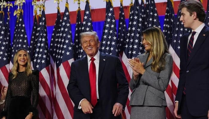 newly elected us president donald trump smiles while accompanied by his wife melania centre lara trump left and son barron at the palm beach county convention center in west palm beach florida us on november 6 2024 photo reuters