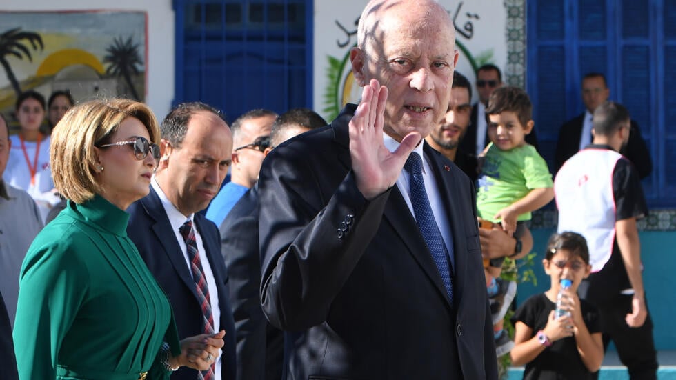 tunisia s president kais saied waves outside a polling station in tunis after casting his vote in the affluent ennasr neighbourhood on october 6 2024 photo afp