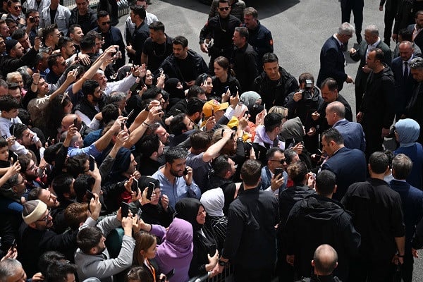 turkish president recep tayyip erdogan and his wife emine erdogan r are surrounded by the supporters as they leave a polling station after casting their votes in the presidential elections photo afp
