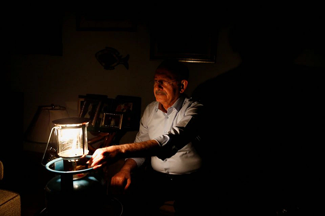 kemal kilicdaroglu leader of the main opposition republican people s party chp works at his home as power had been cut off after he refused to pay his bills for two months in protest at steep hikes in subsidised energy prices in ankara turkey april 21 2022 photo reuters