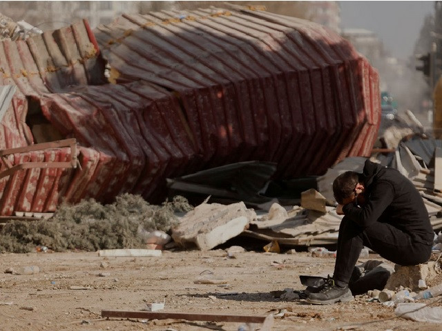 a man reacts as people search the rubble of collapsed apartment blocks for personal belongings in the aftermath of a deadly earthquake in kahramanmaras turkey february 18 2023 photo reuters