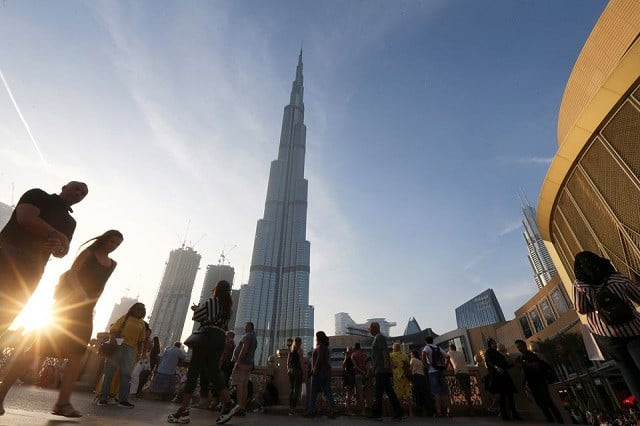 people are seen in front of burj khalifa the world tallest building in dubai united arab emirates march 12 2020 photo reuters people are seen in front of burj khalifa the world tallest building in dubai united arab emirates march 12 2020 photo reuters