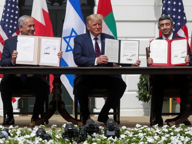 israel s prime minister benjamin netanyahu us president donald trump and united arab emirates uae foreign minister abdullah bin zayed display their copies of signed agreements as they participate in the signing ceremony of the abraham accords normalizing relations between israel and some of its middle east neighbours in a strategic realignment of middle eastern countries against iran on the south lawn of the white house in washington photo reuters