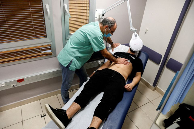 a patient suffering from long covid is examined in the post coronavirus disease covid 19 clinic of ichilov hospital in tel aviv israel february 21 2022 photo reuters a patient suffering from long covid is examined in the post coronavirus disease covid 19 clinic of ichilov hospital in tel aviv israel february 21 2022 photo reuters