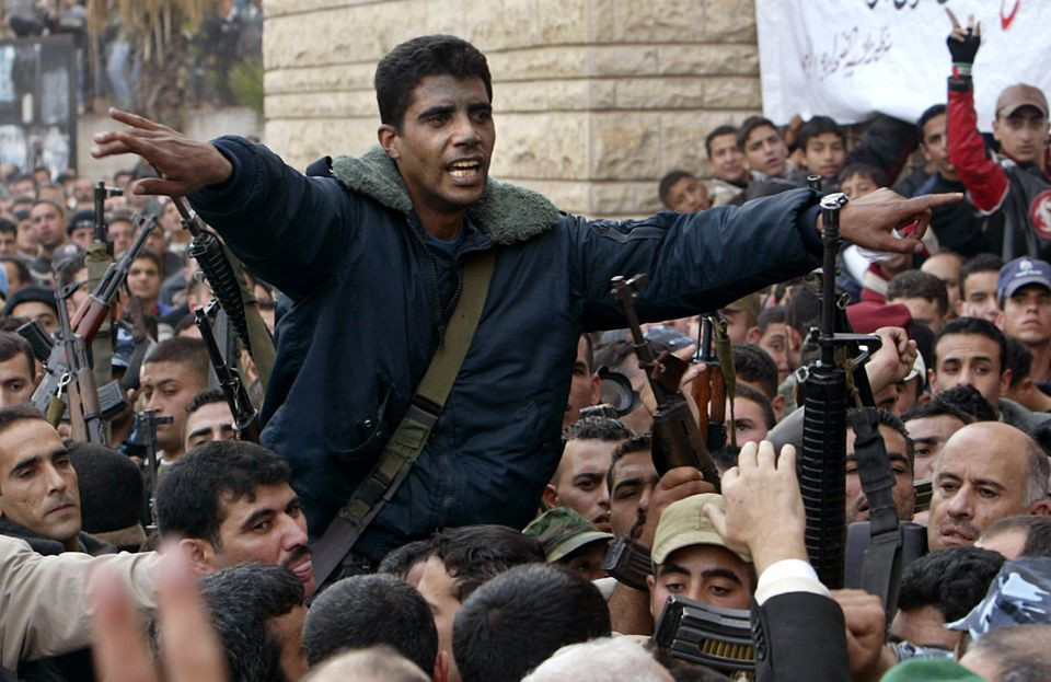 palestinian commander of the militant al aqsa martyrs brigades zakaria zubeid is carried on the shoulders of supporters in jenin in the israeli occupied west bank december 30 2004 reuters