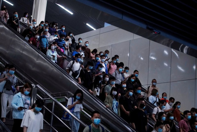 people walk at a subway station following the outbreak of the coronavirus disease covid 19 in shanghai china may 11 2021 reuters people walk at a subway station following the outbreak of the coronavirus disease covid 19 in shanghai china may 11 2021 reuters