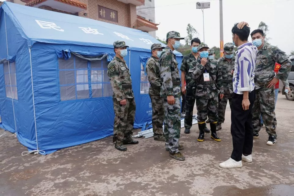 militia members speak with a manager at the entrance of lu village near the site where a china eastern airlines boeing 737 800 plane flying from kunming to guangzhou crashed in wuzhou guangxi zhuang autonomous region china march 22 2022 reuters militia members speak with a manager at the entrance of lu village near the site where a china eastern airlines boeing 737 800 plane flying from kunming to guangzhou crashed in wuzhou guangxi zhuang autonomous region china march 22 2022 reuters