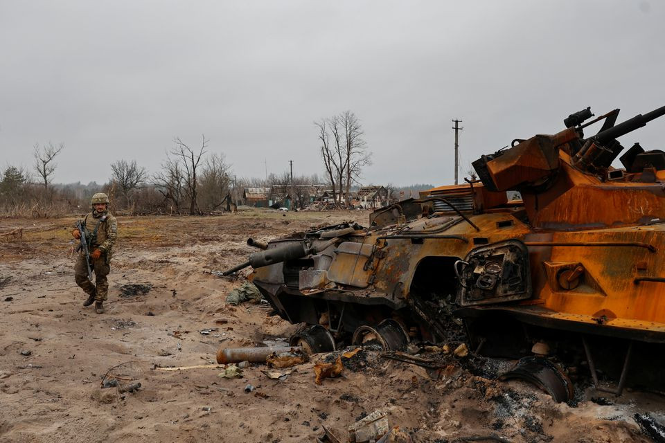 a ukrainian service member inspects destroyed russian btr 82 armoured personal carrier apc in a village near a frontline as russia s attack on ukraine continues in kyiv region ukraine march 31 2022 photo reuters