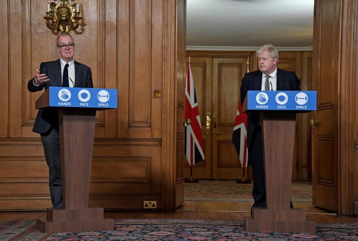 britain s prime minister boris johnson watches chief scientific adviser sir patrick vallance speak during a press conference where he is expected to announce new restrictions to help combat the coronavirus disease covid 19 outbreak at 10 downing street in london britain october 31 2020 alberto pezzali pool via reuters