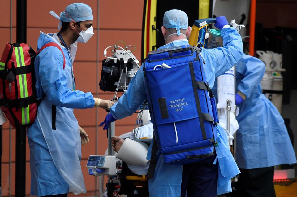 medical workers move a patient between ambulances outside of the royal london hospital amid the spread of the coronavirus disease covid 19 pandemic london britain january 27 2021 photo reuters