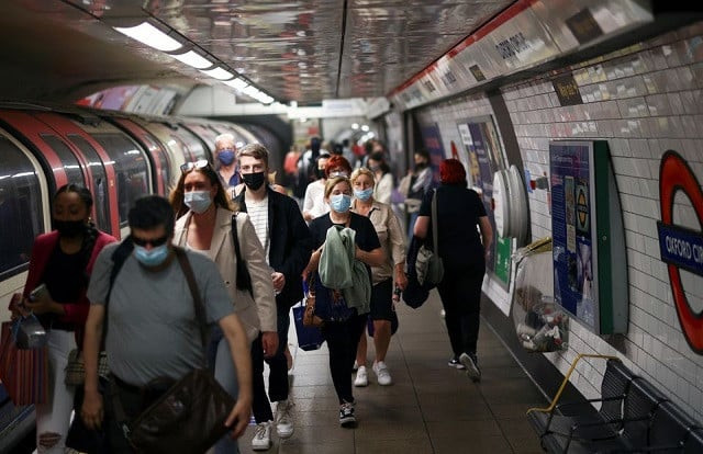 people some wearing protective face masks walk along a platform at oxford circus underground station amid the coronavirus disease covid 19 pandemic in london britain july 4 2021 photo reuters