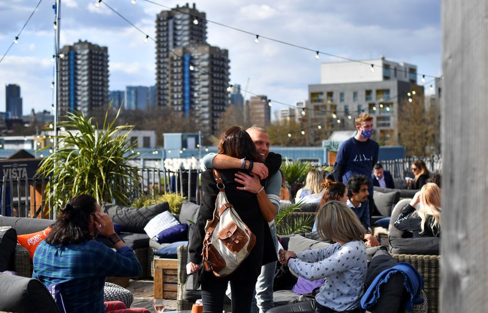 people hug at the skylight rooftop bar as the coronavirus disease covid 19 restrictions ease in london britain april 12 2021 photo reuters