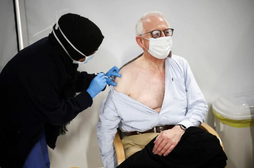a person receives a dose of the pfizer coronavirus disease covid 19 vaccine at a vaccination site at the westfield shopping centre in london britain december 3 2021 photo reuters