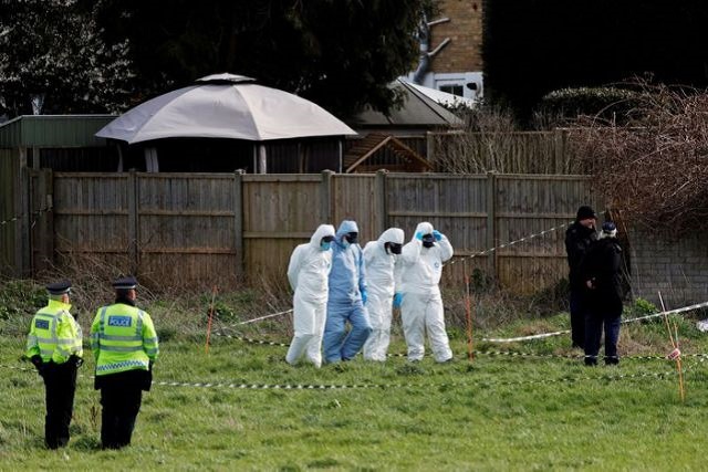 police officers search an area of grass land behind a house as the investigation into the disappearance of sarah everard continues in deal britain march 12 2021 photo reuters