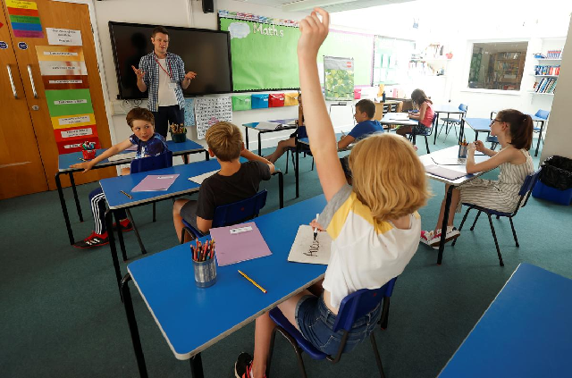 a child gestures in a classroom at watlington primary school during the last day of school amid the covid 19 outbreak in watlington britain july 17 2020 photo reuters
