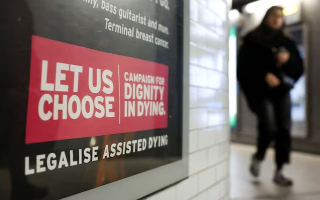 a tube passenger walks past an assisted dying rights billboard ahead of the parliamentary debate on friday in london britain on november 26 2024 photo reuters