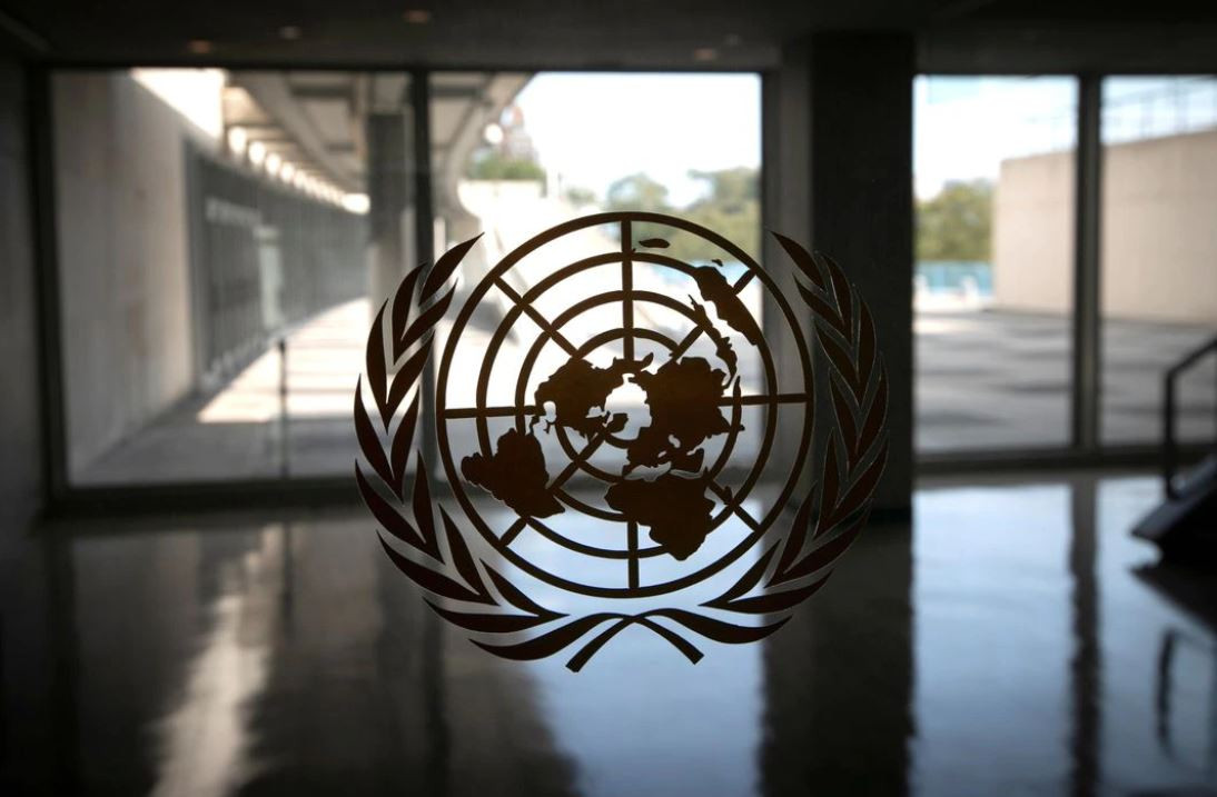 the united nations logo is seen on a window in an empty hallway at united nations headquarters in new york september 21 2020 photo reuters