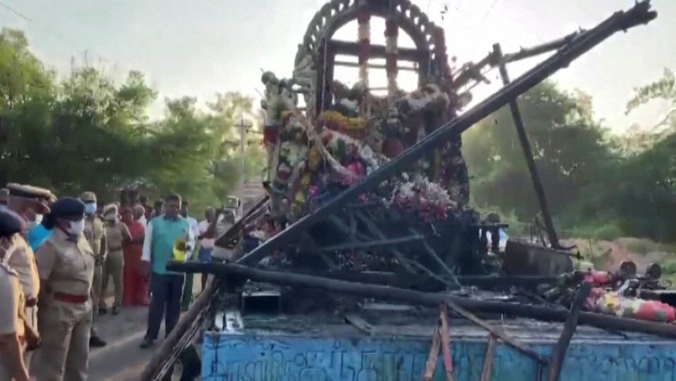 people gather around a chariot that was damaged after a high voltage power wire fell on it killing at least 11 people during a procession in a temple festival in kalimedu village thanjavur district india april 27 2022 still image obtained from video photo reuters