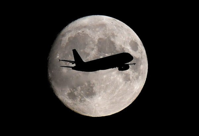 a passenger plane passes in front of the moon as it makes its final landing approach to heathrow airport in london britain september 12 2019 photo reuters a passenger plane passes in front of the moon as it makes its final landing approach to heathrow airport in london britain september 12 2019 photo reuters