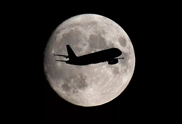 a passenger plane passes in front of the moon as it makes its final landing approach to heathrow airport in london britain september 12 2019 photo reuters a passenger plane passes in front of the moon as it makes its final landing approach to heathrow airport in london britain september 12 2019 photo reuters