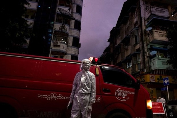 a medical staff wearing a protective suit stands near an ambulance amid the outbreak of the coronavirus disease in yangon myanmar photo reuters