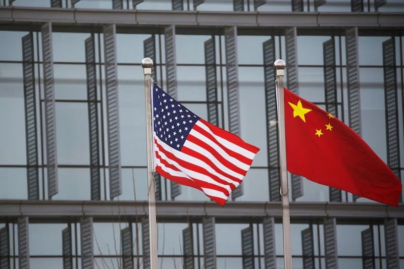 chinese and us flags flutter outside the building of an american company in beijing china january 21 2021 photo reuters