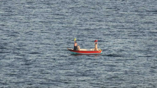 two iranian mariners signal for assistance after eight days adrift in gulf waters before their rescue by the us navy photo afp two iranian mariners signal for assistance after eight days adrift in gulf waters before their rescue by the us navy photo afp