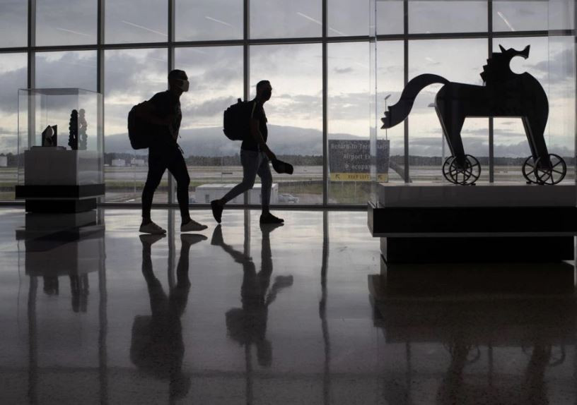 passengers walk past artwork between terminals at iah george bush intercontinental airport amid the coronavirus disease covid 19 outbreak in houston texas us july 21 2020 photo reuters file