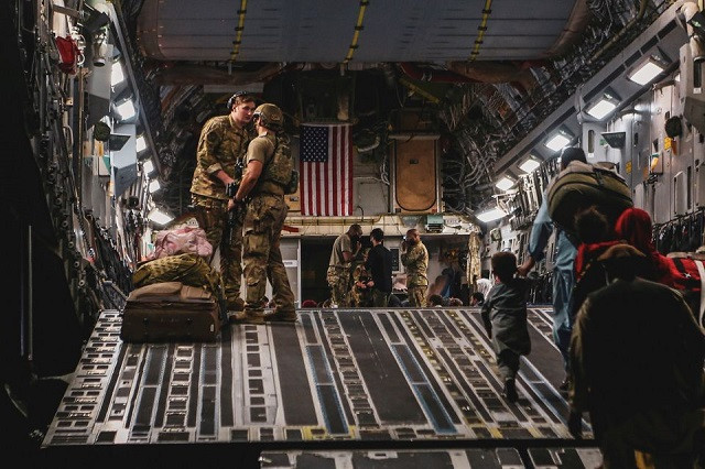 evacuees board a boeing c 17 globemaster iii during an evacuation at hamid karzai international airport in kabul afghanistan august 23 2021 photo reuters