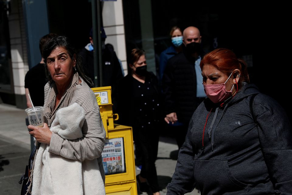 a woman walks without a protective face mask after the centers for disease control and prevention cdc announced new guidelines regarding outdoor mask wearing and vaccinations during the outbreak of the coronavirus disease covid 19 in manhattan new york city us april 27 2021 photo reuters file