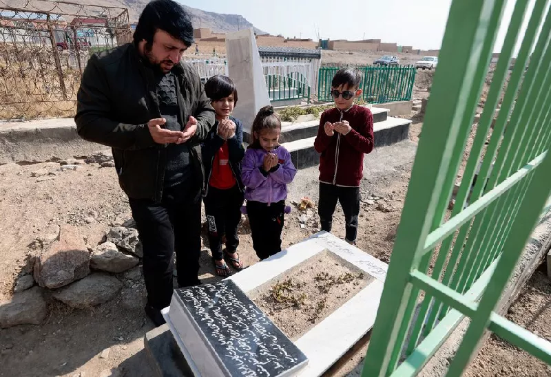 ajamal ahmadi stands with his nephews as they pray by the grave of arwin 7 a relative who was a victim of a us drone strike that killed 10 civilians including seven children in kabul afghanistan november 7 2021 photo reuters ajamal ahmadi stands with his nephews as they pray by the grave of arwin 7 a relative who was a victim of a us drone strike that killed 10 civilians including seven children in kabul afghanistan november 7 2021 photo reuters